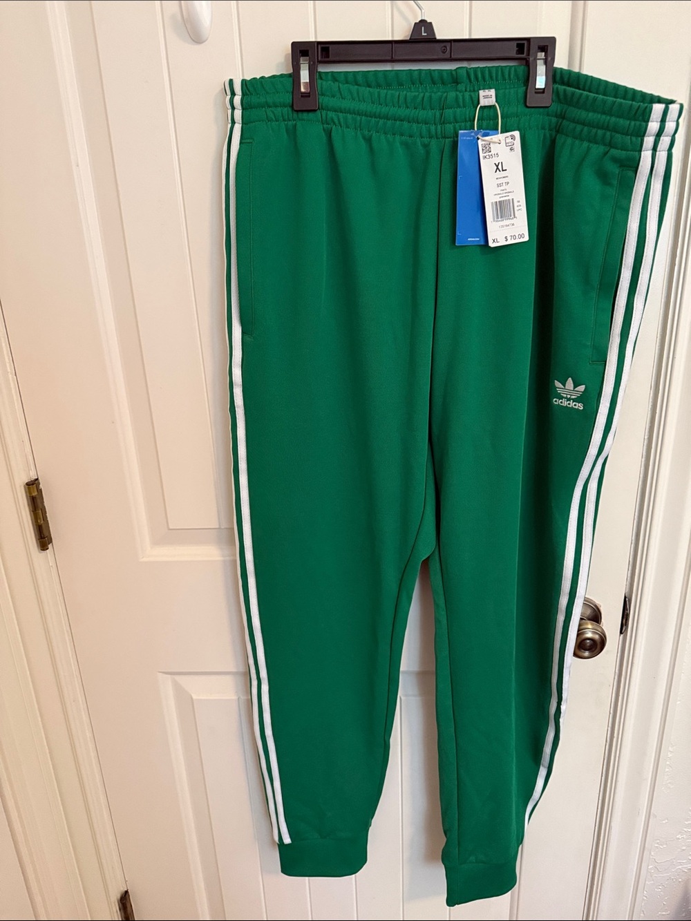 Adidas Originals SST track pants in a green